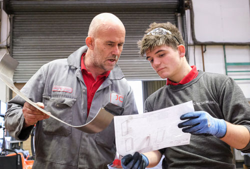 JC Metalworks employee working with an apprentice